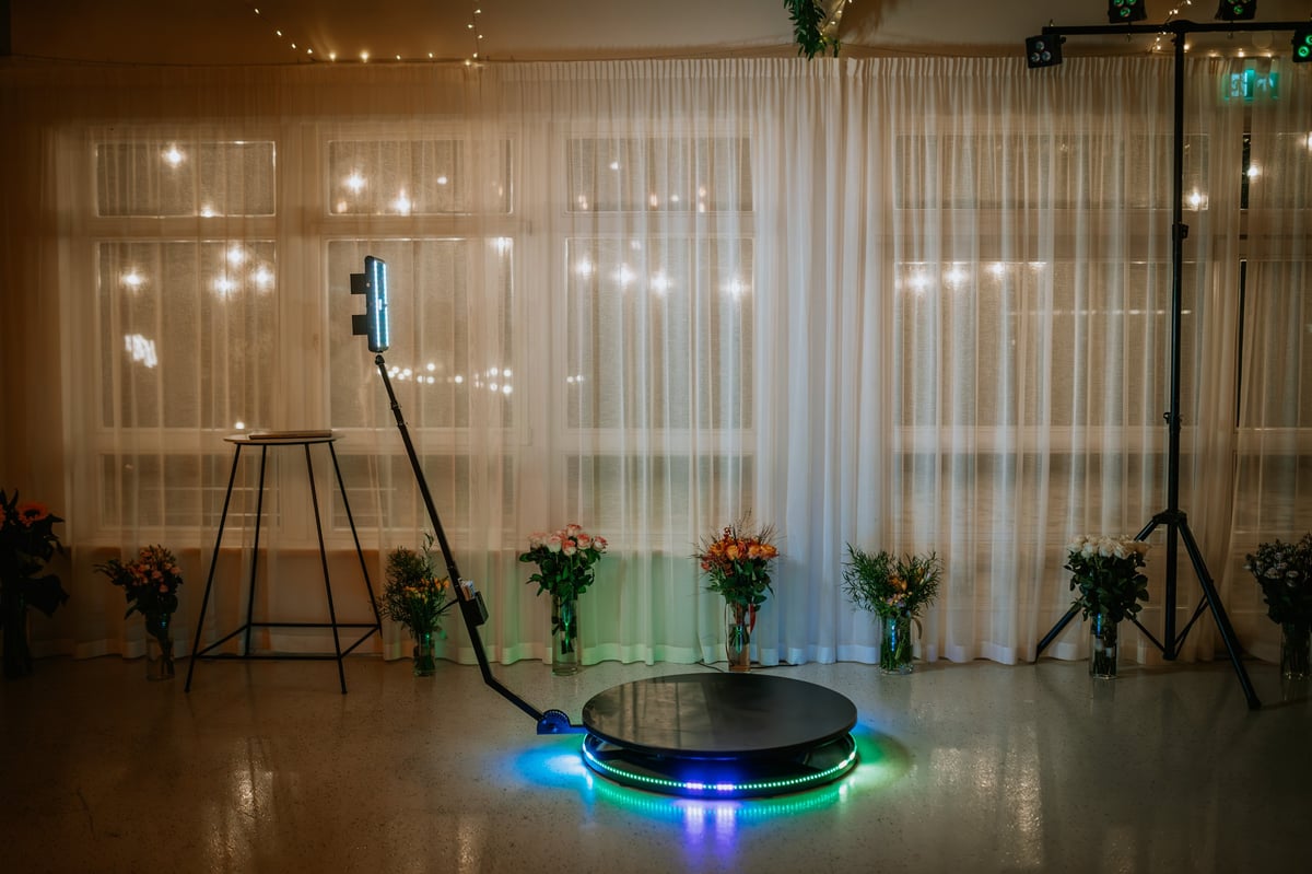A 360-degree photo booth setup with LED lights and a rotating platform